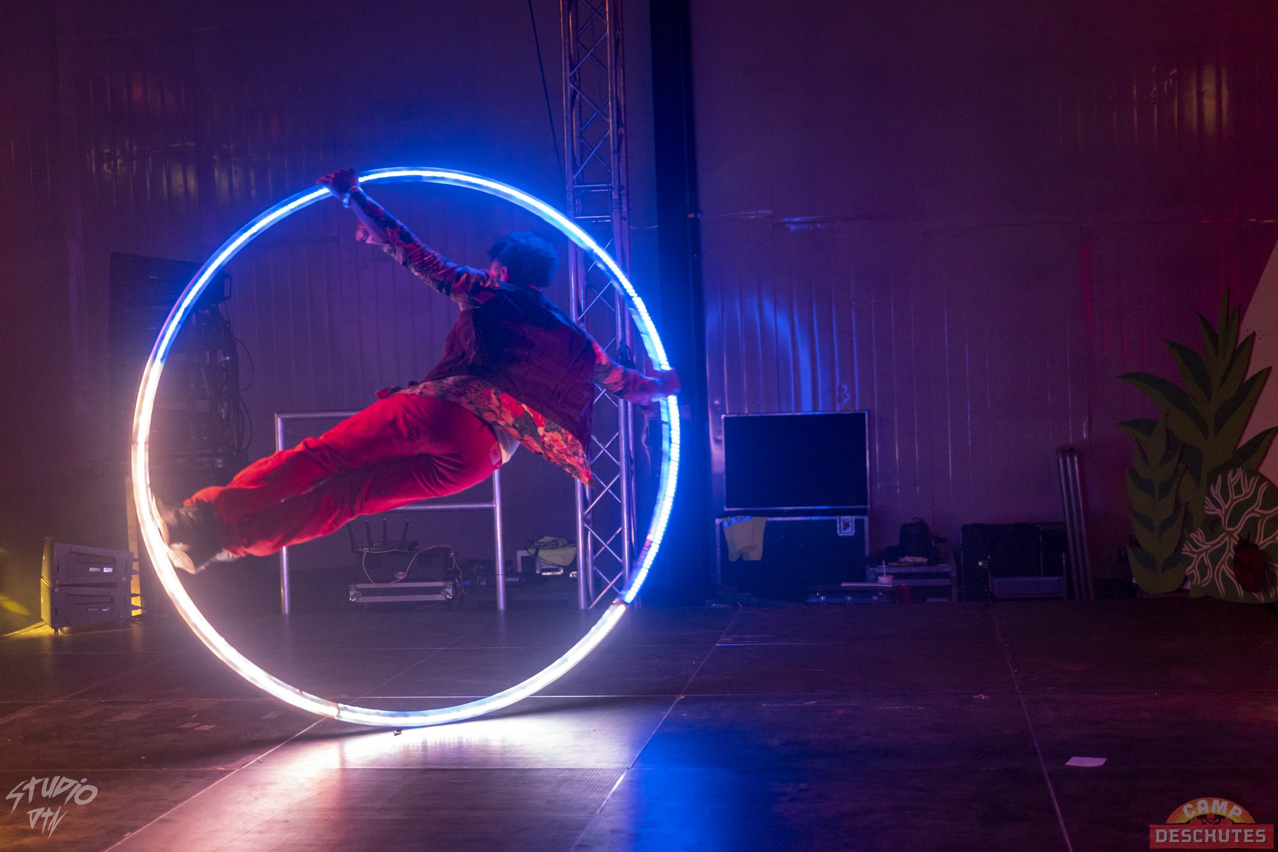 Circus performer on a Cyr (pronounced Seer) wheel) that lights up with LED's